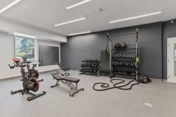 A spacious fitness center with exercise equipment and weights